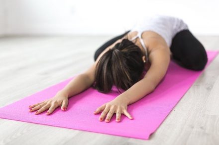 femme en train de s'étirer sur un tapis de gym