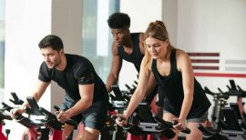 trois pratiquants de sprint sur un vélo indoor
